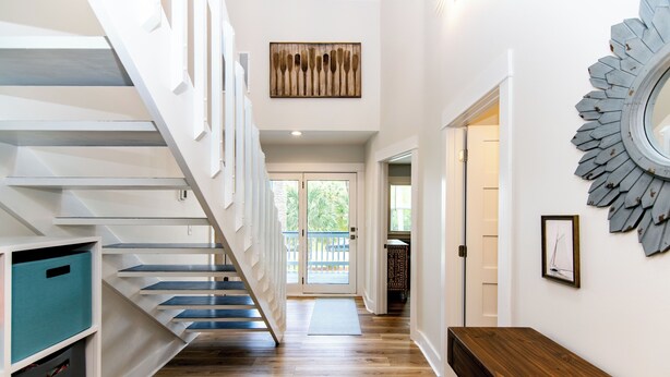 A staircase with white railings and blue steps, leading to a door with a glass panel. - Ocean Shade | Edisto Beach Vacation Rental | Private Pool Oasis | Walk to Beach (Edisto Beach)