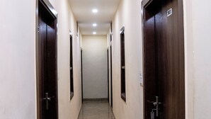 A corridor with doors on both sides, leading to rooms. - Hotel Shivay Palace (Agra)