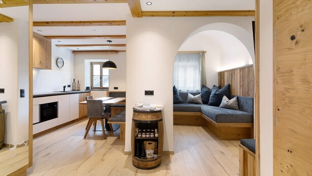 A modern interior with a kitchen, dining area, and seating space.