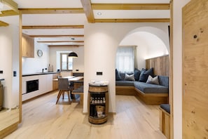 A modern interior with a kitchen, dining area, and seating space.