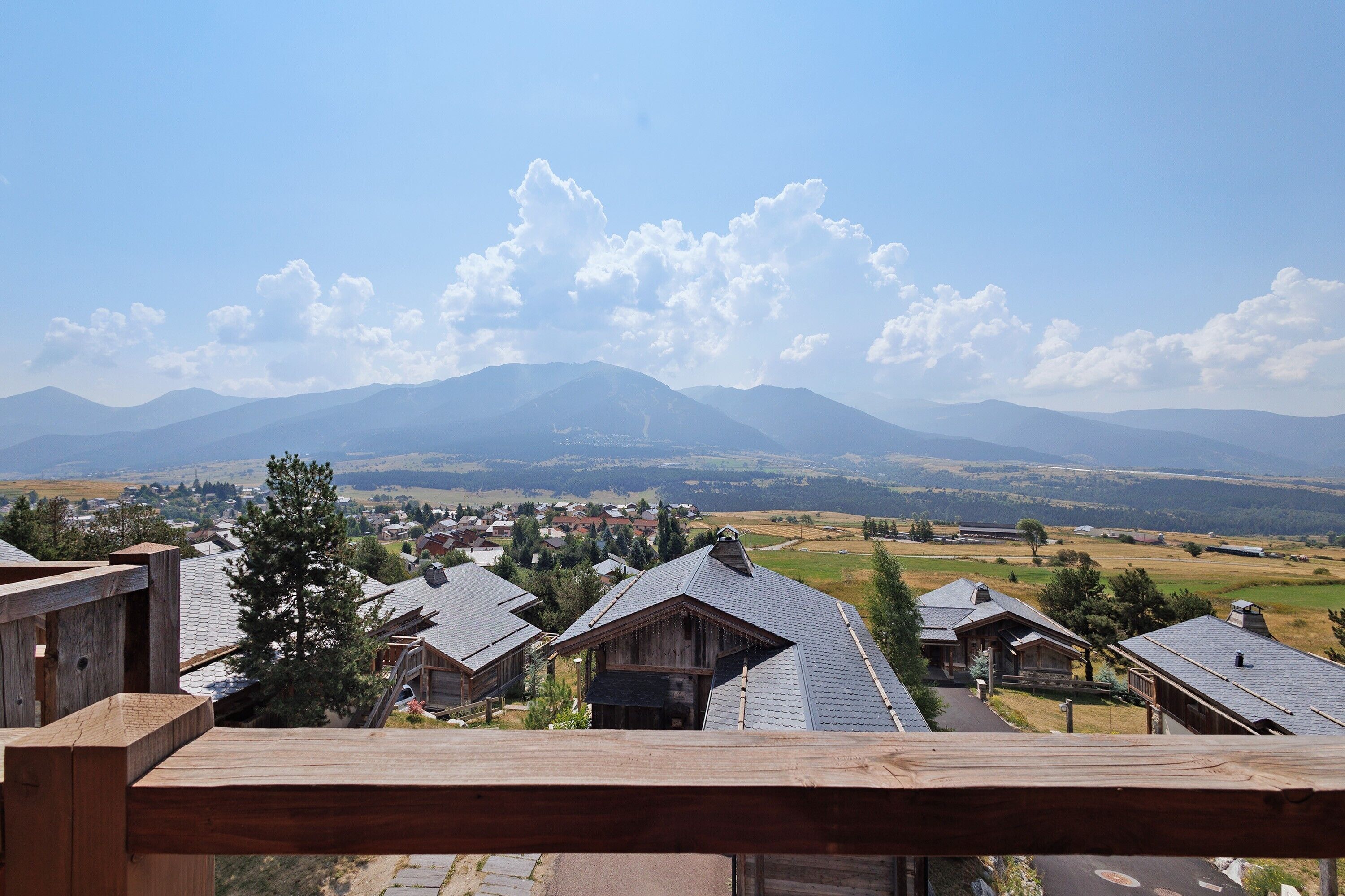 A view of a mountain range with a small town in the valley below.