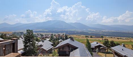 A view of a mountain range with a small town in the valley below.