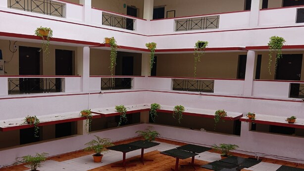 A multi-level courtyard with potted plants and tables. - Hotel St Thomas International Centre (Chennai)