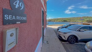 A building with a sign indicating 'SEA ROOMS' and the number '49'.