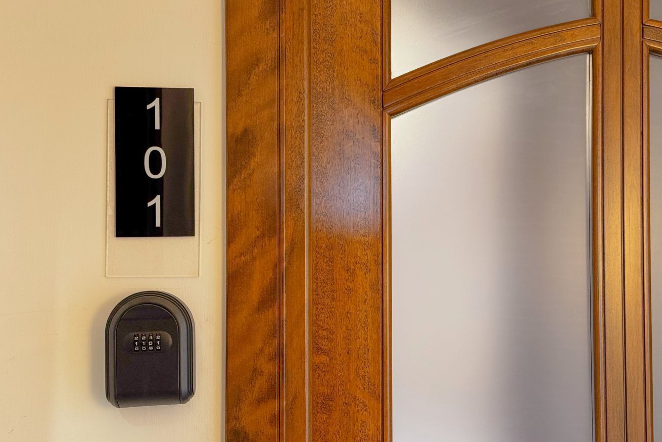 A door with a number plate '101' and a keypad lock.