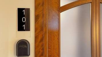 A door with a number plate '101' and a keypad lock.