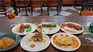 A dining table with various dishes and drinks.