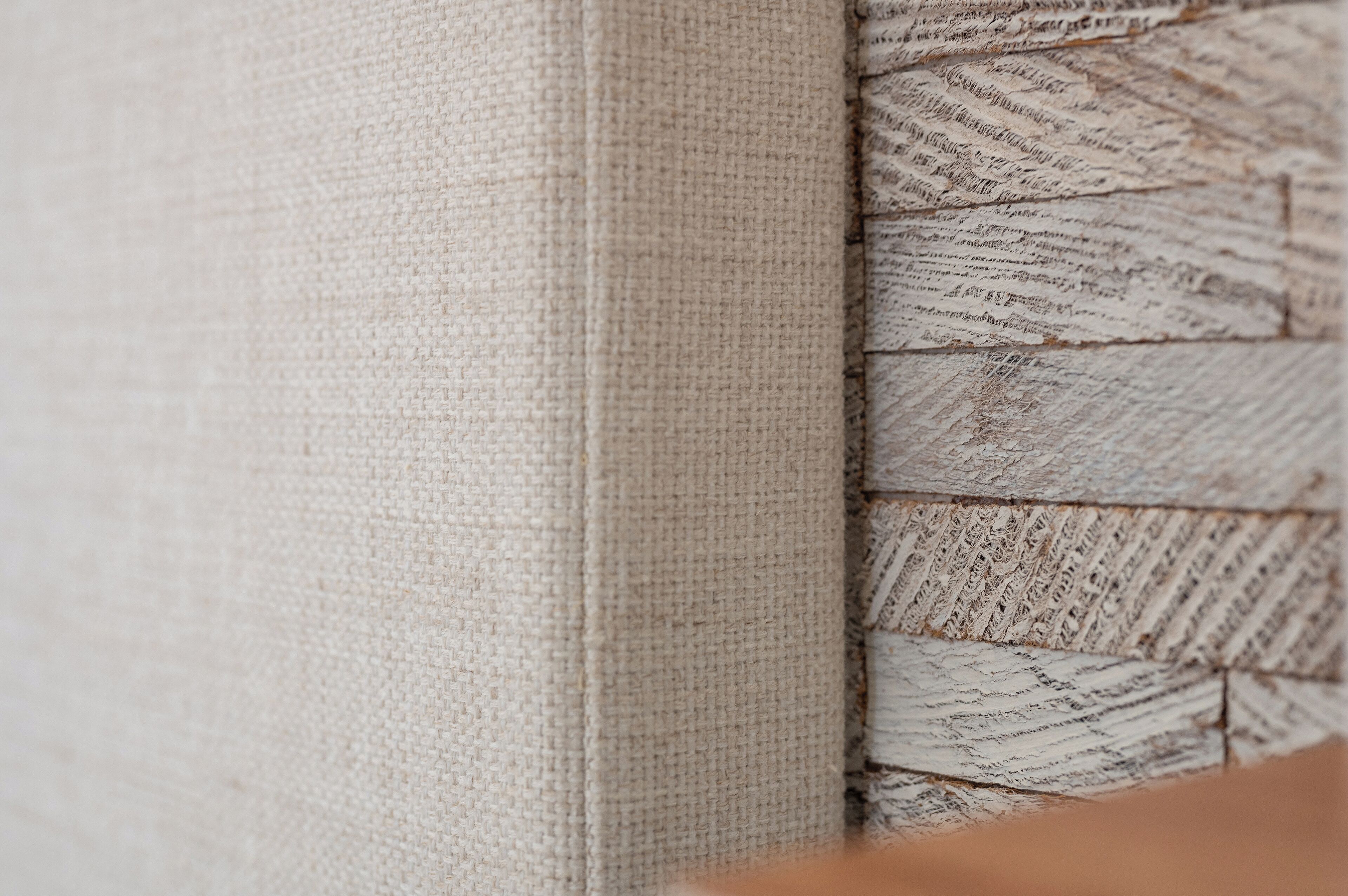 A close-up of a textured fabric with a woven pattern, likely part of a piece of furniture or decor.