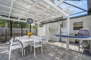 Enjoy meals al fresco with water views and the Florida breeze. - Outdoor Coastal Living: Pool, Hot Tub, Patio, Dock (Siesta Key)