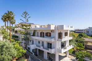 A modern two-story residential building with balconies, surrounded by greenery and other houses. - Ardians Home, Be on Holidays (Chania)