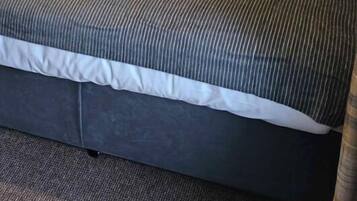 Restful retreat with a neatly made bed and comfortable seating area.
