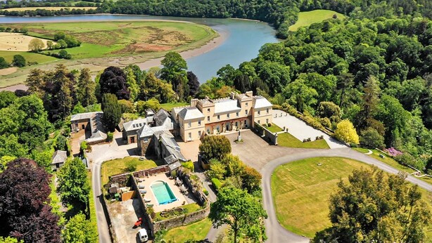 A large estate with a swimming pool, a winding road, and a river in the background. - Castle in Tamar with Pool and Gardens (Saltash)
