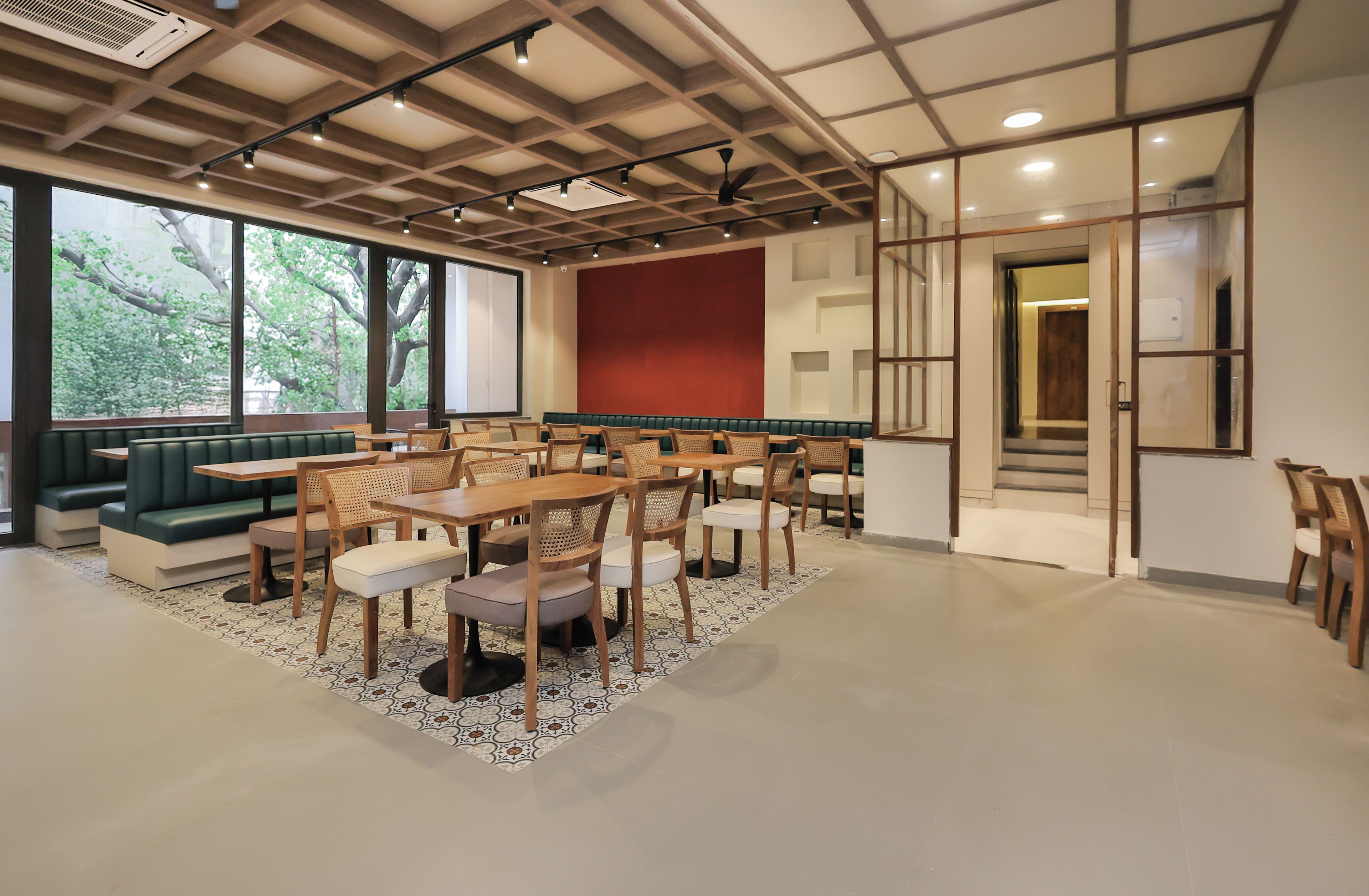 A conference room with a long table, chairs, and a green sofa.
