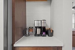 Enhanced and fully stocked coffee bar provided with keurig, drip, pour over and french press along with coffee, creamer and sugar - perfect for fueling your morning before exploring Gillham Park or the Nelson-Atkins Museum.