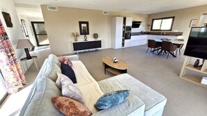 Relax in this inviting living space with a sofa, coffee table, and flat-screen TV.