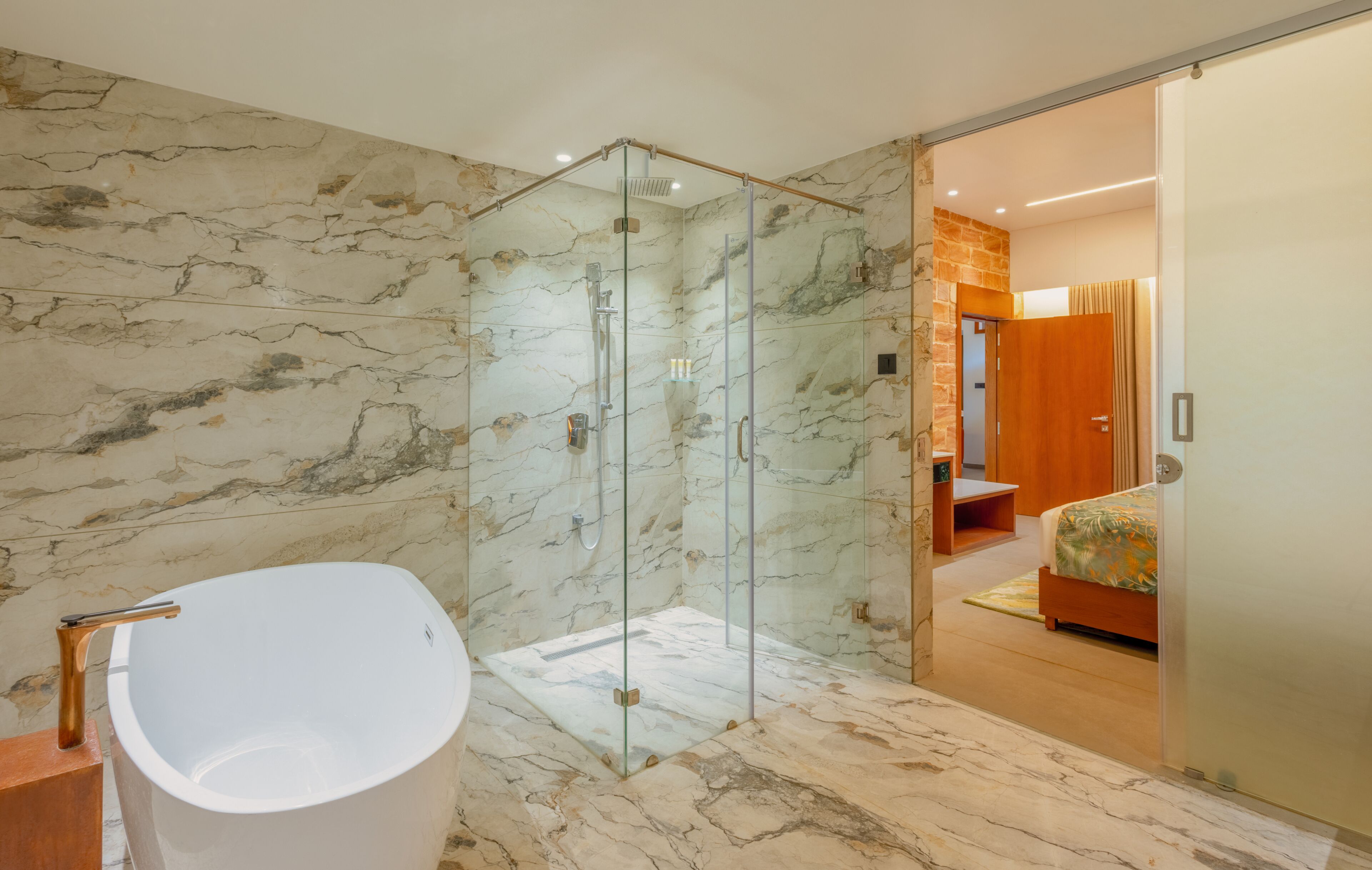 A modern bathroom with a glass-enclosed shower, a freestanding bathtub, and a wooden bench.