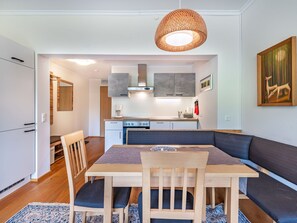 Une cuisine moderne avec un coin repas comprenant une table, des chaises et un canapé.