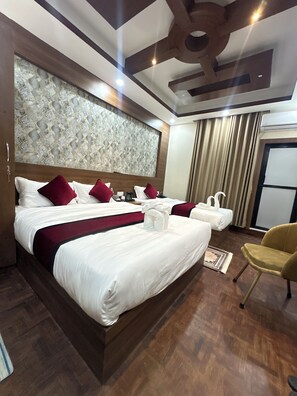 A hotel room with a large bed, a smaller bed, a chair, and a decorative ceiling. - Lazimpat Boutique Hotel (Kathmandu)