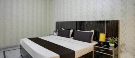 A bedroom with a bed, bedside tables, and a nightstand.