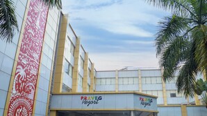 A modern building with a prominent entrance, a large vertical mural, and the name "PRAVEG Resort" displayed on the facade. - Praveg Rezort Silvassa (Silvassa)