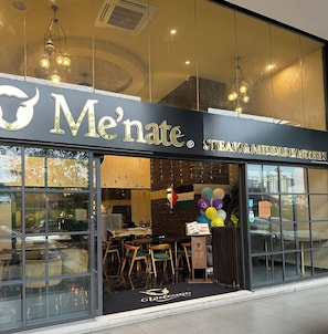 Welcome to Me'nate Steak & Middle Eastern, where a warm ambiance awaits.