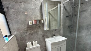 A modern bathroom with a shower, toilet, and sink. - 526A Farnham Rd  (Slough)