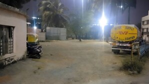 A gated area with a water supply truck parked near a building. - PPH Living Royal Imperial Comforts (Bengaluru)