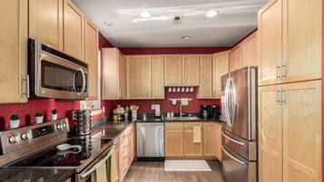 Enjoy cooking in this well-equipped kitchen with a microwave, oven, dishwasher, and refrigerator.