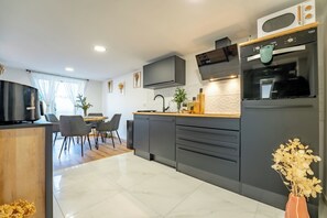Enjoy cooking in this well-equipped kitchen with oven, microwave, and dining area.