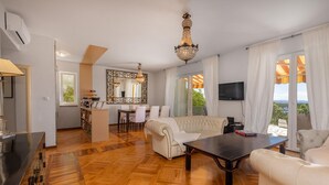 A spacious living area with a sofa, a dining table, and a TV. - Pet friendly apartment in Banjol with WiFi (Banjol)
