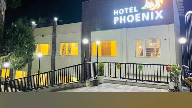 A hotel named "Hotel Phoenix" with a modern facade, illuminated signage, and a well-lit entrance area. - HOTEL PHOENIX (Mussoorie)