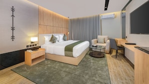A modern hotel room with a large bed, bedside tables, a desk, a chair, and a TV. - Aryash hotel  (Abha)