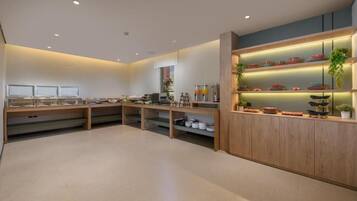 A modern kitchen with wooden cabinets, built-in shelves, and a variety of kitchenware.