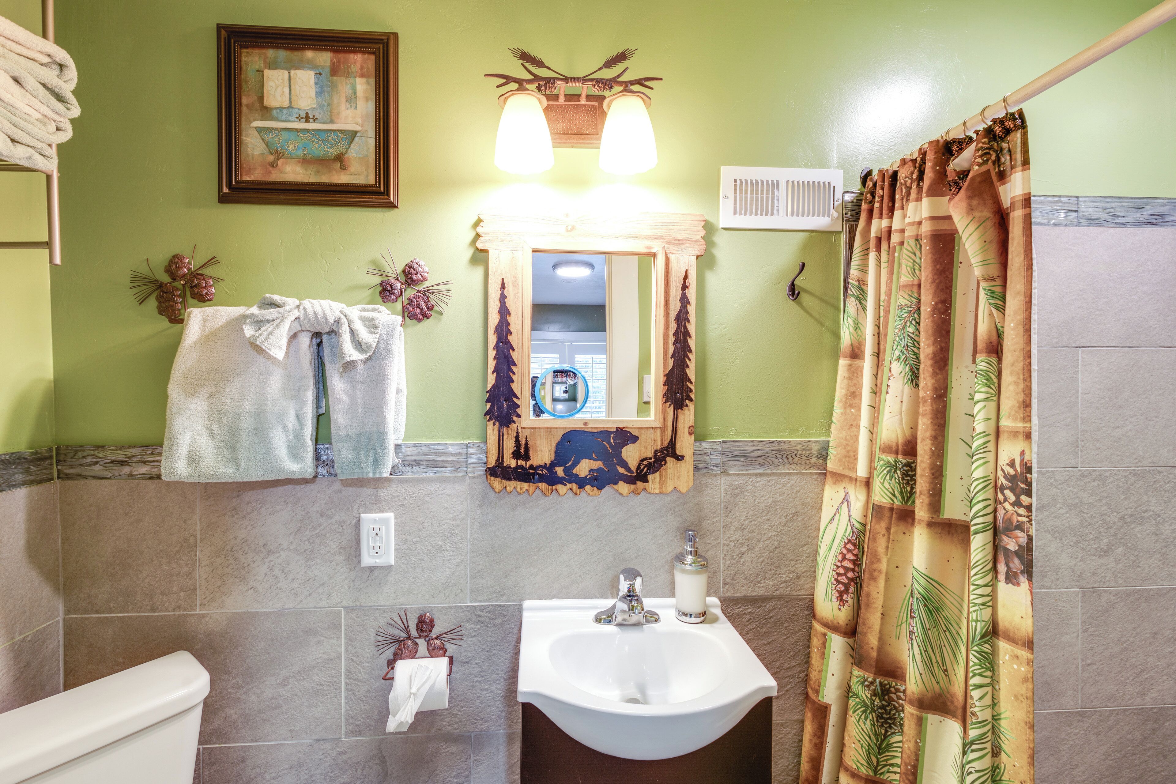 Un baño con lavamanos, inodoro y cortina de ducha.