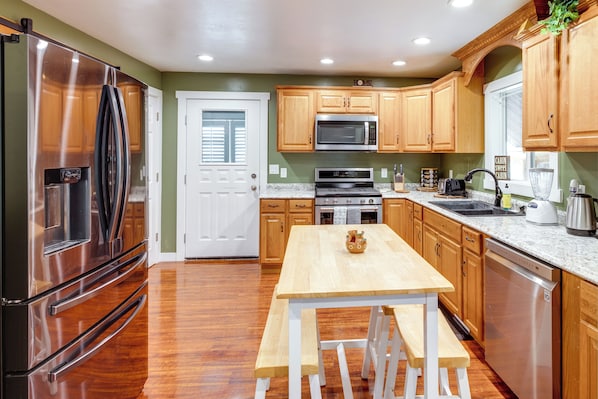 Enjoy cooking in this well-equipped kitchen with a refrigerator, microwave, and dishwasher.