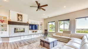 A modern living room with a fireplace, a large sofa, and a coffee table. - Family Hideaway w/ Hillside Views in Temecula! (Temecula)