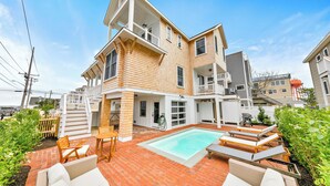 A two-story house with a swimming pool, outdoor seating, and a fenced garden area. - Steps From Sand & Fun: Beach Haven Retreat w/ Pool (Beach Haven)