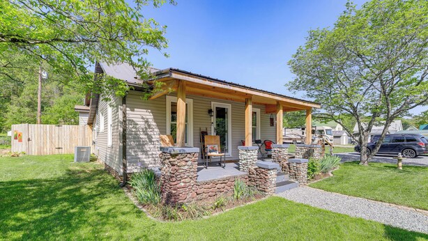 A single-story house with a porch, stone pillars, and a small garden area. - Walk to River & Trails: Cozy Damascus Cottage! (Damascus)