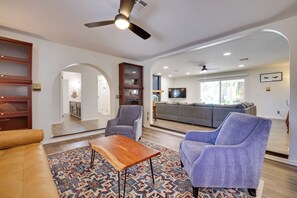 A spacious living room with a sofa, armchairs, a coffee table, and a patterned rug. - Covered Patio & Pool: Luxe Home in Las Vegas (Las Vegas)