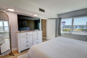 A bedroom with a bed, dresser, and a view of the beach. - 146 El Matador 2 Bedroom Condo (Fort Walton Beach)