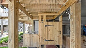 A wooden outdoor kitchen area with a built-in sink and a small step leading up to it. - Fall 2026 Rate Drop! 2BR/2BA - Great Location! Book Now! (Port St. Joe)