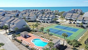 A residential area with multiple houses, a tennis court, and a swimming pool. - Fall 2026 Rate Drop! 2BR/2BA - Great Location! Book Now! (Port St. Joe)