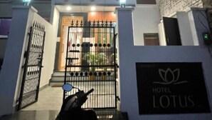 A modern hotel with a prominent entrance, a signboard, and a well-lit facade. - Hotel Lotus Inn (Varanasi)