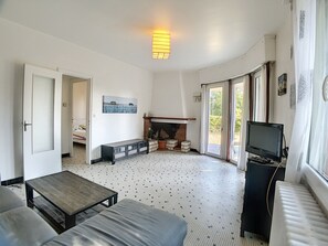 Cozy living space with a fireplace, TV, and seating area.