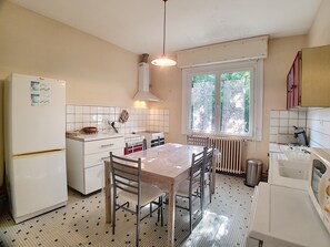 Enjoy cooking in this well-equipped kitchen with a central island and dining table.