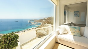 A balcony with a view of the sea, a white sofa, and a small plant. - Eagles Nest Mykonos Adults Only (Tourlos)