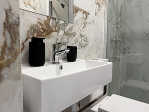 Shower, hair dryer, towels, toilet paper