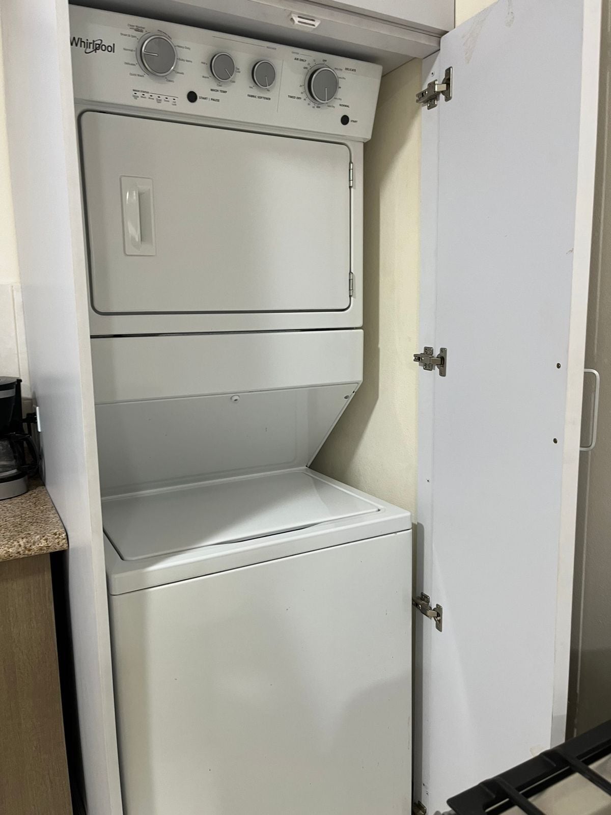 A compact, white Whirlpool washer and dryer unit with a control panel featuring multiple dials and buttons.