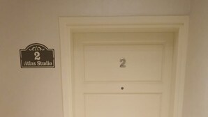 A white door with the number 2 and a sign above it that reads "Atlas Studio".