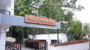 A hotel entrance with a sign reading "HK Grand Inn". - Hk Grand Inn By K Hotels (Yercaud)